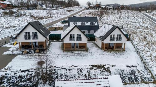 an aerial view of a house in the snow at Dom z Widokiem na Góry i Jacuzzi - "Domki na Słonecznym Wzgórzu" in Lądek-Zdrój