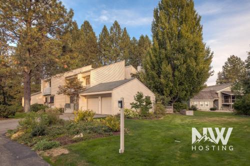 a house with a nw housing sign in a yard at Twin Lakes Village 3-Story Townhouse Golf Views Steam Shower Wet Bar Game Room Pool in Rathdrum