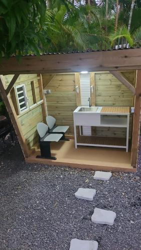 a small bathroom with two toilets and a sink at LA DESIRADE SAINTE-ANNE in Sainte-Anne