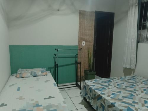 a bedroom with two beds and a window at Pousada Recanto do Mar in Tutóia