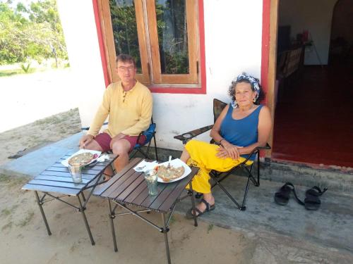 a man and a woman sitting at a table at House of Freedom in Hambantota