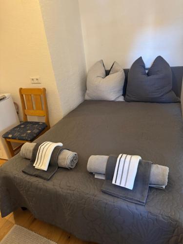 a bed with two pillows and towels on it at Haus mit Herz in Sulzbach-Rosenberg