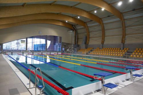 a large swimming pool with many lanes in it at Apartament przy basenie in Katowice