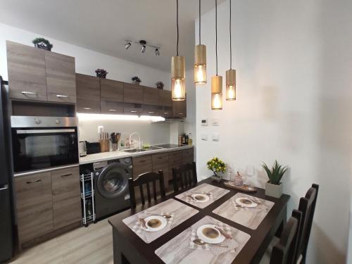a kitchen with a table with chairs and a dining room at Coffee Apartment on Sunny Day 6 Complex in Tŭnkovo