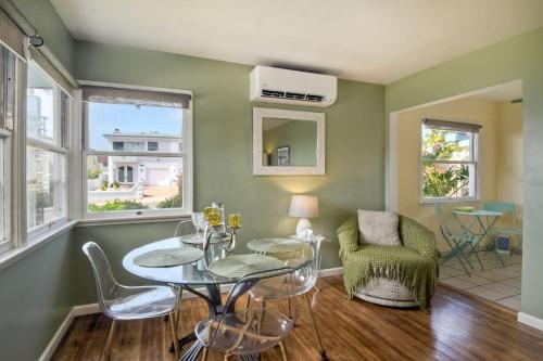a living room with green walls and a table and chairs at 167 Tamarack in Carlsbad