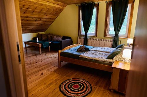 a bedroom with a bed with a cat laying on it at Agroturystyka Gaładuś - Maria Dabulis Dusznica 1 in Sejny
