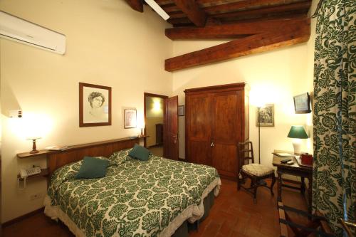 a bedroom with a bed and a table and a chair at Rovezzano B&B in Florence