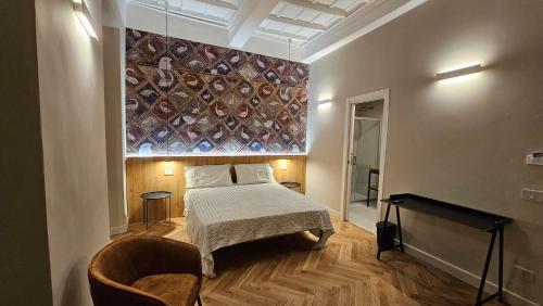 a bedroom with a bed and a painting on the wall at Antica Dimora Palazzo Ciprani in Anagni