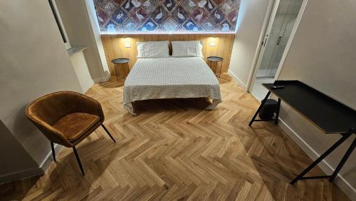 a bedroom with a bed and a table and a desk at Antica Dimora Palazzo Ciprani in Anagni