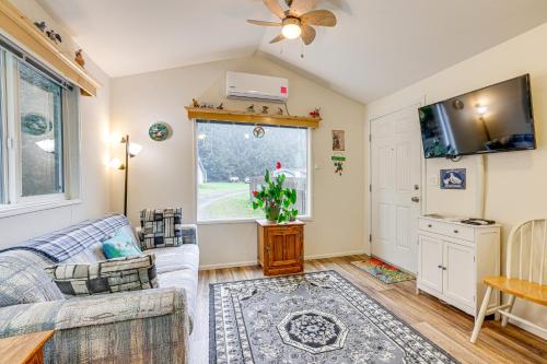 a living room with a couch and a tv at Remote Workers Welcome Tiny Home in Port Angeles! in Port Angeles