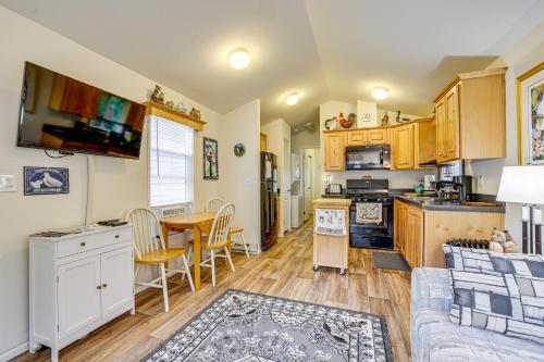 a kitchen and living room with a couch and a table at Remote Workers Welcome Tiny Home in Port Angeles! in Port Angeles