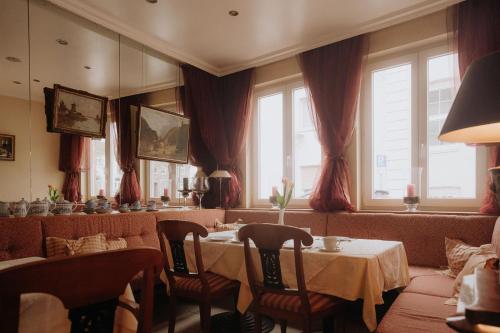 a restaurant with a table and chairs and windows at Pension Am Museum in Glückstadt