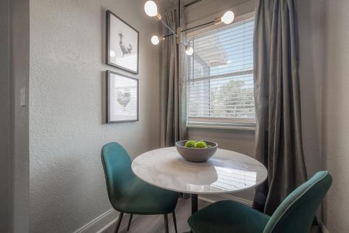 a dining room with a table and chairs and a window at Updated Condo in Heart of Tampa 1569 in Tampa
