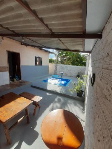 a patio with a table and a bench and a pool at Casa MTB in Pirenópolis