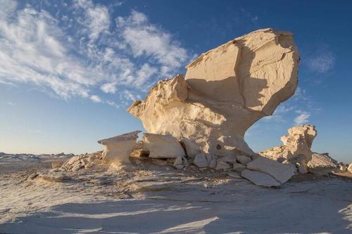 a large rock in the middle of a desert at Oasis Panorama in Bawiti