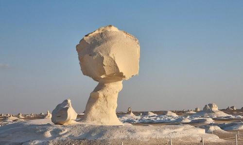 a large rock formation in a snowy field at Oasis Panorama in Bawiti