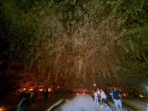 a group of people standing in a cave at night at Oasis Panorama in Bawiti