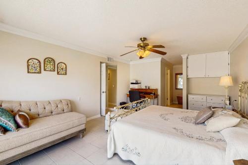 a bedroom with a bed and a couch at Serenity in Longboat Key