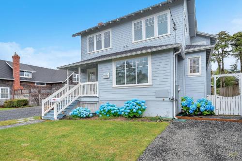 a house with blue flowers in the front yard at Hydrangea House in Seaside