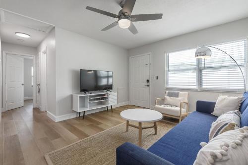 a living room with a blue couch and a tv at Updated Waterfront Condo in Apollo Beach 1572 in Apollo Beach