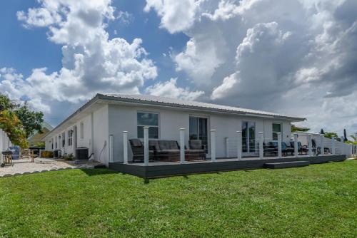 a small white house with a large yard at Updated Waterfront Condo in Apollo Beach 1572 in Apollo Beach