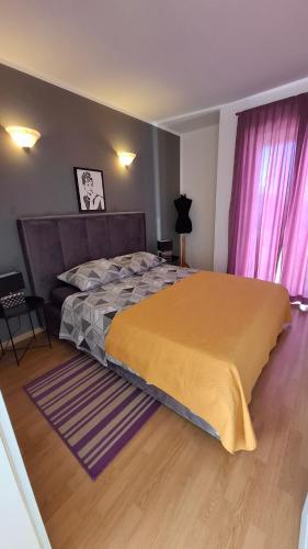 a bedroom with a large bed and pink curtains at Apartments Kimm's Hideaway in Poreč