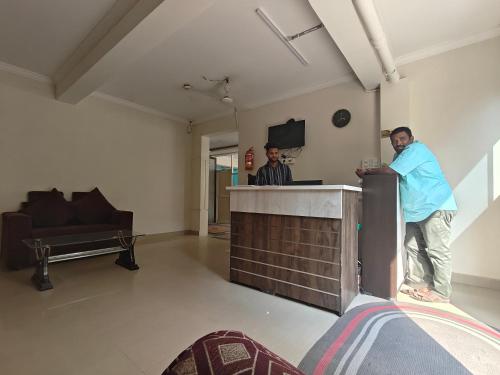 two men standing at a bar in a room at IMPERIAL Retreat in Hyderabad