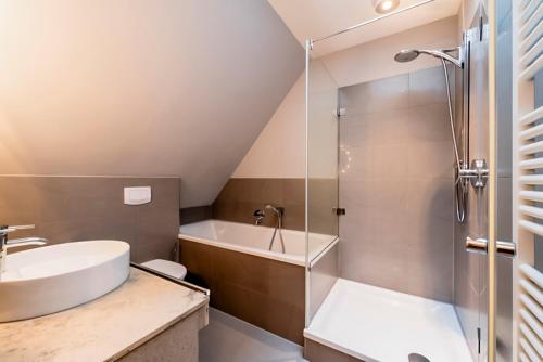a bathroom with a shower and a toilet and a sink at Bauernkate Seerose in Rankwitz