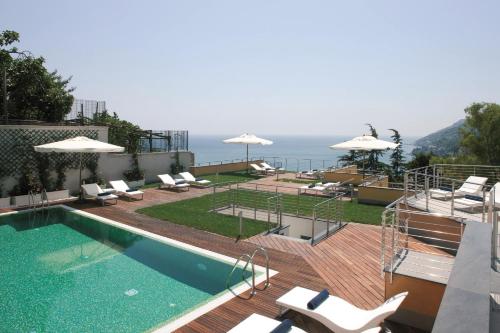 a patio area with a pool and lawn chairs at Relais Paradiso in Vietri sul Mare