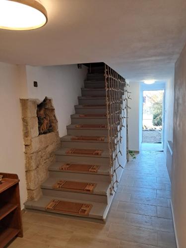 a staircase in a house with a stone wall at Chalupa U Medvídků in Jiřetín pod Jedlovou