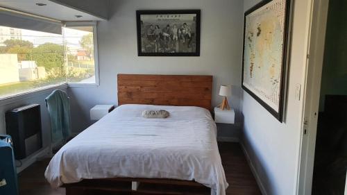 a bedroom with a bed and a window at Wide duplex 200 meters from the sea in Mar del Plata