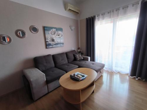 a living room with a couch and a table at Apartments Kimm's Hideaway in Poreč