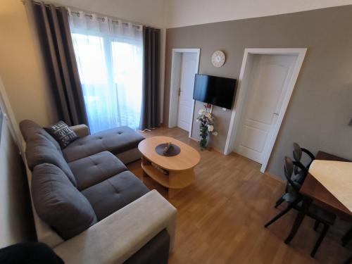 a living room with a couch and a table at Apartments Kimm's Hideaway in Poreč