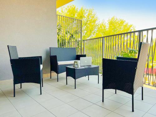 a patio with chairs and a table with a laptop on it at Green Living with Terrace & Garage by NDP rent in Milan