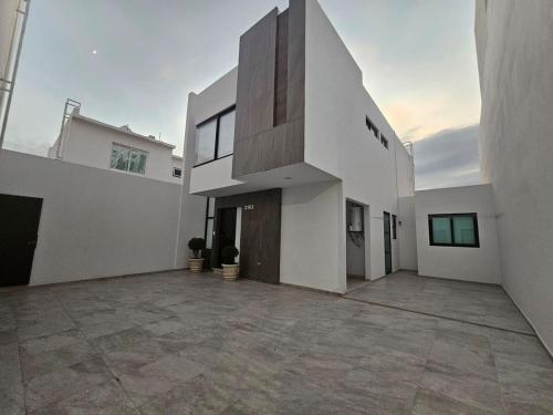 a large white house with a large driveway at AC0 Casa de lujo en privada Altana in Culiacán