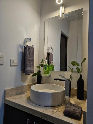 a bathroom with a sink with a large mirror at AC0 Casa de lujo en privada Altana in Culiacán