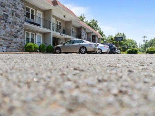 two cars parked in front of a building at The Luxe Nook, Premier Studio in Scenic Congers in Congers