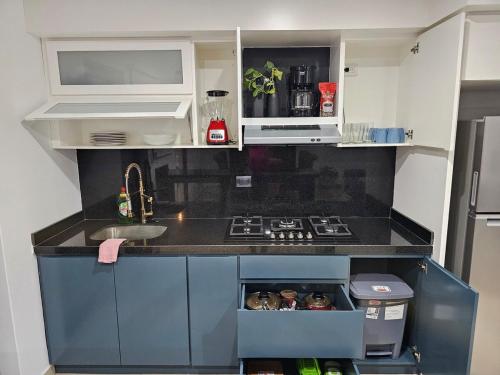 a small kitchen with a sink and a stove at AC0 Casa de lujo en privada Altana in Culiacán