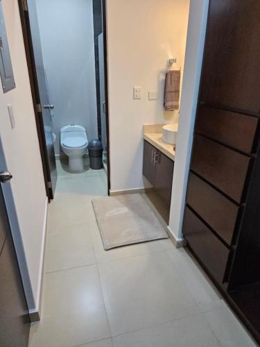 a bathroom with a toilet and a sink at AC0 Casa de lujo en privada Altana in Culiacán