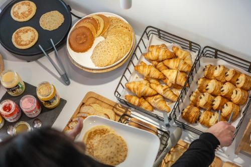 a table topped with lots of different types of bread at Grand Hôtel Niort Centre in Niort