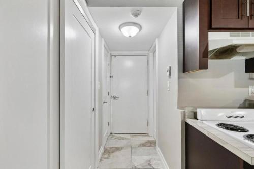 a kitchen with a door leading to a hallway at The Luxe Nook, Premier Studio in Scenic Congers in Congers