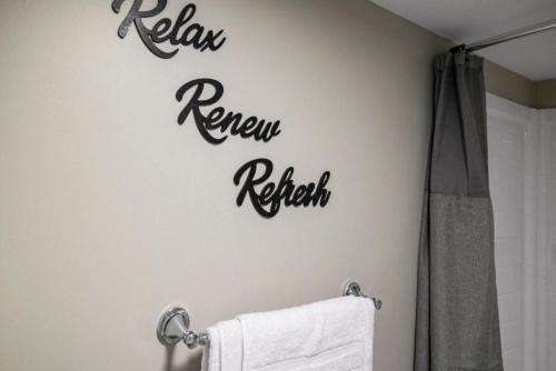 a bathroom with a toilet sign on the wall at The Luxe Nook, Premier Studio in Scenic Congers in Congers