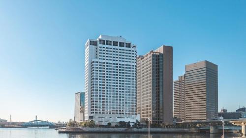 a group of tall buildings next to a river at ANA Holiday Inn Tokyo Bay by IHG in Tokyo