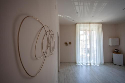 a mirror hanging on a wall in a room at Airport Luxury Rooms in Naples