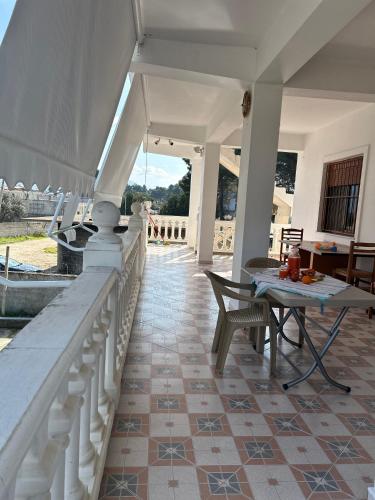 a patio with a table and chairs on a house at Kiki's Rooms 2 in Vlorë