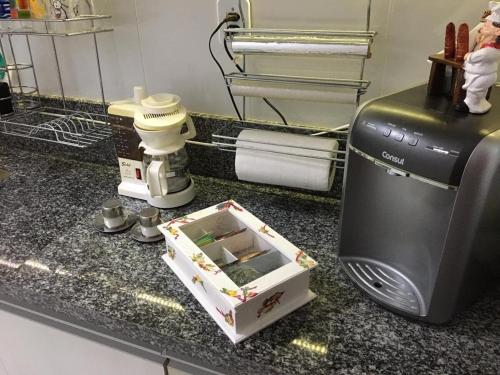 a kitchen counter with a microwave and a box on it at Amenity at the Best of Aracaju 2 Beds in Aracaju