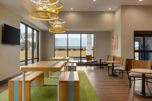 a dining room with tables and chairs and windows at Spark By Hilton Nashville At Opryland in Nashville