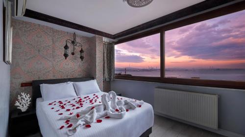 a bedroom with a bed with a view of the ocean at Mytra Hotel in Istanbul