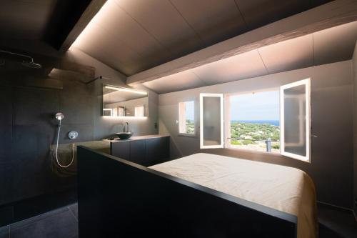a bedroom with a large bed and a window at Mazet design vue mer 4 guests in Sainte-Maxime