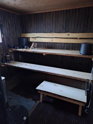 a row of wooden shelves in a room at Lisman Lumo in Kittilä